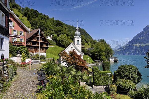 View of the village with the Roman Catholic Church of St Idda, Lake Lucerne in the background, Bauen, Canton, Uri, Switzerland