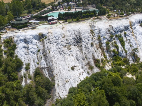 White limestone formation with lush vegetation, geological structure, aerial view, Akkaya Travertines, Bolu Province, Turkey