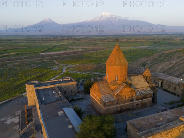 Historical monastery in the morning light with Mount Ararat in the background, aerial view, monastery Chor Wirap, Chor Virap, deep dungeon, in the background Mount Ararat and Little Ararat, located in Turkey, Ararat province, Armenia