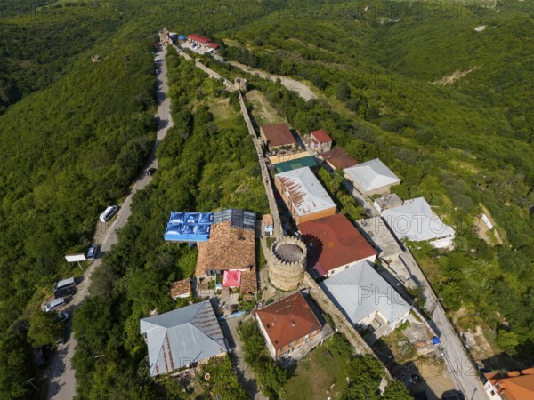 View of a village along a stone wall with towers, embedded in green hills and forests, aerial view, city wall, Sighnaghi, Signagi, Kakheti Province, Greater Caucasus, Georgia, Near East