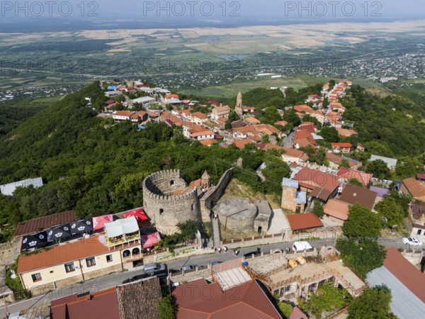 Historic town with a castle and red roofs, situated on a green hill with a wide view, aerial view, tower of the town wall, Sighnaghi, Signagi, Kakheti Province, Greater Caucasus, Georgia, Near East
