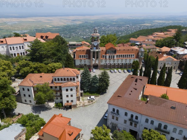 A square with a tower and traditional buildings framed by a panoramic view, aerial view, Sighnaghi, Signagi, Kakheti Province, Greater Caucasus, Georgia, Near East