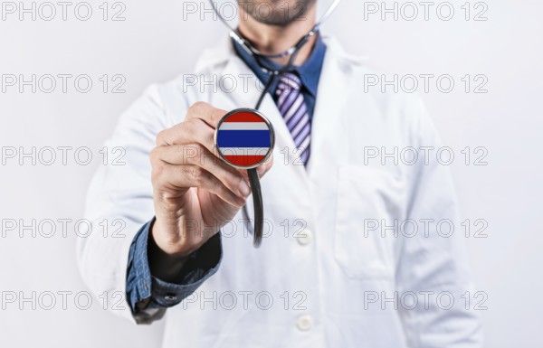 Thailand healthcare system, doctor holding stethoscope. Thailand health and medical insurance concept