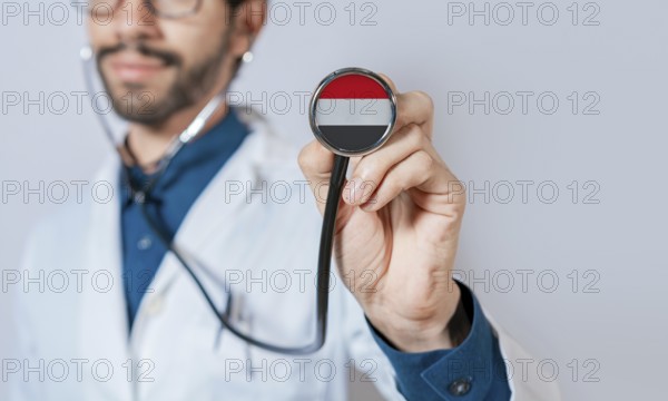 Doctor holding stethoscope with Yemen flag. Yemen health and care concept, Yemen flag on stethoscope