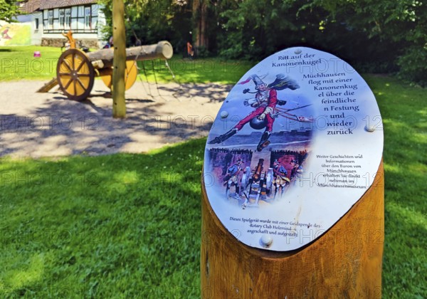 Sign of Munchausen's ride on the cannonball on the children's playground in the Munchausen town of Bodenwerder, Weserbergland, Lower Saxony, Germany