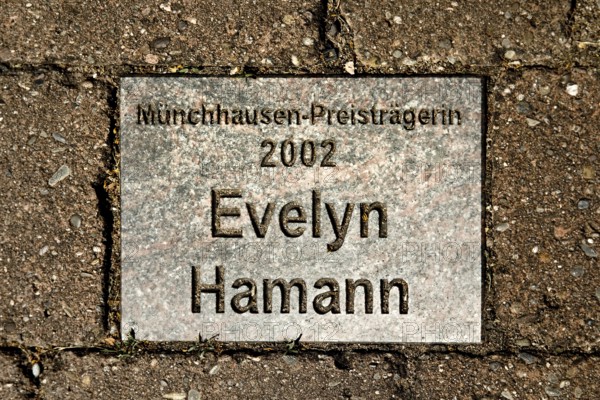Sign for the 2002 Münchhausen Prize winner Evelyn Hamann in the Münchhausen town of Bodenwerder, Weserbergland, Lower Saxony, Germany