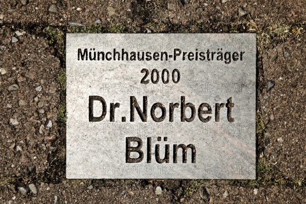 Sign for the Münchhausen Prize winner of 2000 Dr Norbert Blüm in the Münchhausen town of Bodenwerder, Weserbergland, Lower Saxony, Germany