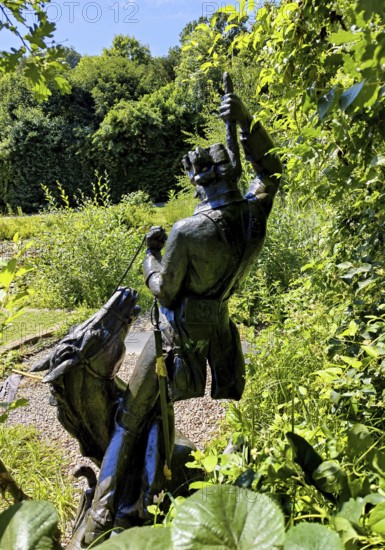 Statue of the swamp scene Pulling yourself out of the swamp by your own bootstraps in the Münchhausen town of Bodenwerder, Weserbergland, Lower Saxony, Germany