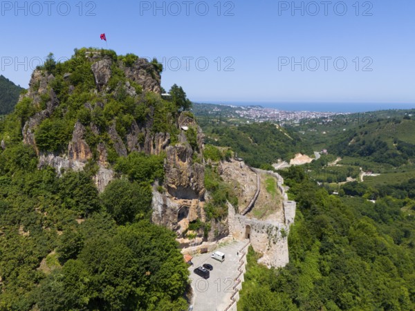 Panorama of a rocky hill with flag and wide valley view, aerial view, Ünye Castle, Ünye Kalesi, Inkur, Ünye, Ordu Province, Turkey