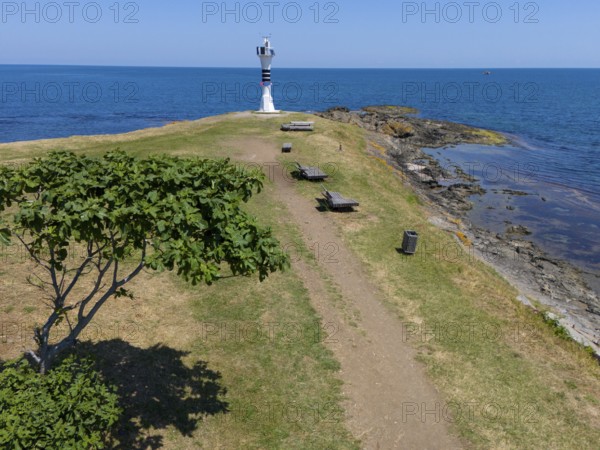 Path leading to a lighthouse on the coast, surrounded by trees and benches in a summer landscape, aerial view, Yason Burnu lighthouse, Cape Jason, Çaytepe, Ordu province, Turkey