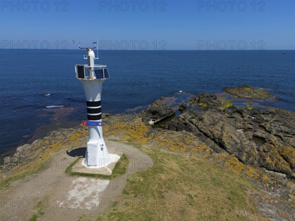 Close-up of a lighthouse on a rocky coast with the wide sea and blue sky, aerial view, Yason Burnu lighthouse, Cape Jason, Çaytepe, Ordu province, Turkey