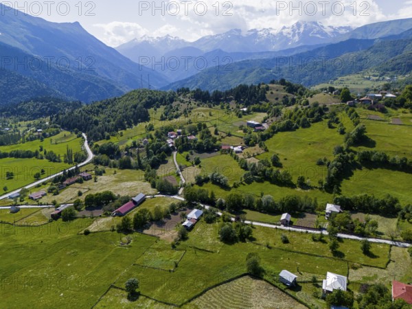 Hilly landscape with small settlements and green fields surrounded by mountains, aerial view, landscape near Iskari, Mingrelia and Upper Svaneti, Samegrelo-Zemo Svaneti, Svaneti, High or Greater Caucasus, Georgia