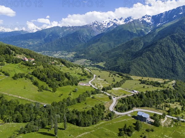 Panoramic view of a valley with roads and forests, surrounded by mountains under a clear sky, aerial view, landscape near Iskari, Mingrelia and Upper Svaneti, Samegrelo-Zemo Svaneti, Svaneti, High or Greater Caucasus, Georgia