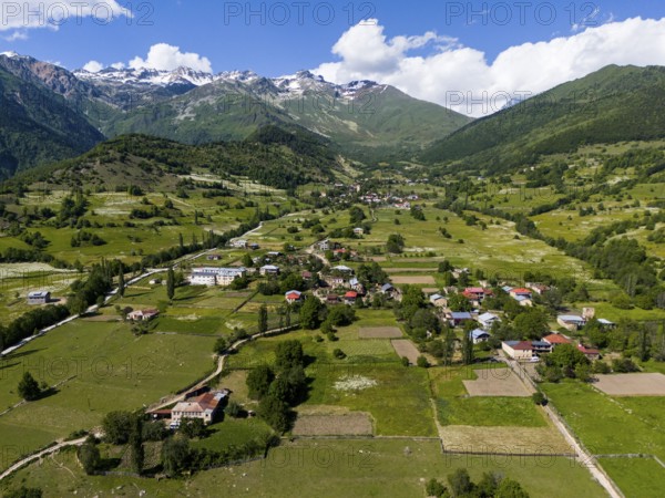 Vast landscape with villages and fields under a blue sky, framed by mountains, aerial view, landscape near Iskari, Mingrelia and Upper Svaneti, Samegrelo-Zemo Svaneti, Svaneti, High or Greater Caucasus, Georgia