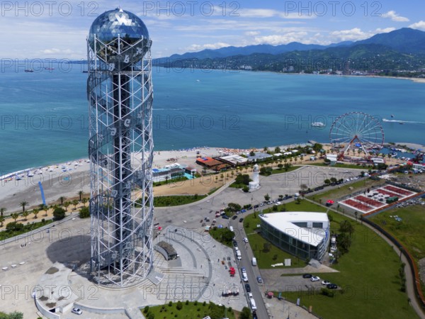 Steel construction tower overlooking the sea, Ferris wheel and surrounding coastline on a sunny day, aerial view, Alphabetic Tower, Georgian Alphabet Tower, Miracle Park, Batumi, Black Sea, Adjara region, Adjara, Autonomous Republic, Georgia