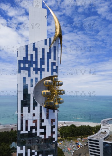 Futuristic building with golden element and golden gondolas on the coast overlooking the sea, aerial view, Batumi Tower with Ferris wheel, Batumi, Black Sea, Adjara region, Adjara, autonomous republic, Georgia