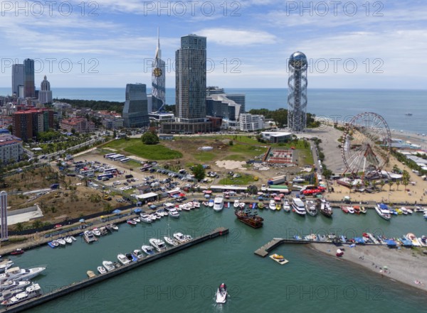 Harbour city with yachts, skyscrapers and a Ferris wheel on the coast in sunny weather, aerial view, Batumi, Black Sea, Adjara region, Adjara, autonomous republic, Georgia