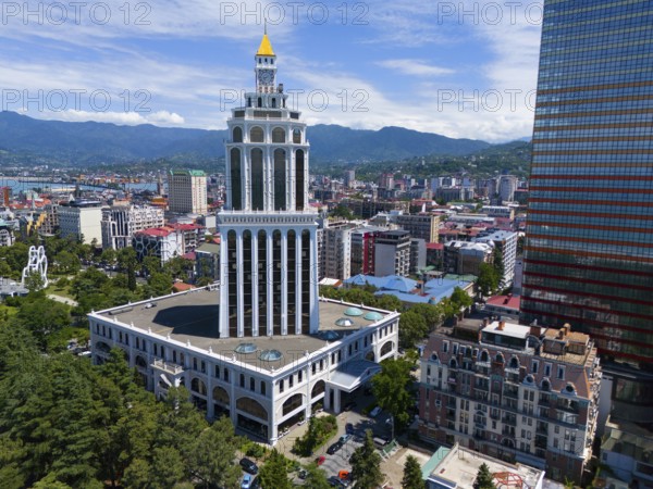 Tall building in a city with mountain backdrop and blue sky, aerial view, Sheraton Hotel, Batumi, Black Sea, Adjara region, Adjara, autonomous republic, Georgia