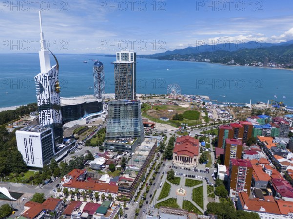 Modern high-rise buildings near the coast, blue sky and amusement park with Ferris wheel, aerial view, Batumi, Black Sea, Adjara region, Adjara, autonomous republic, Georgia