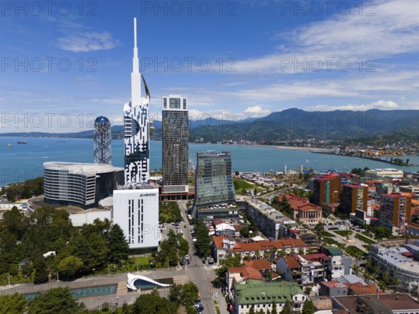 Modern high-rise buildings on the seashore with mountain panorama and clear sky, aerial view, Batumi, Black Sea, Adjara region, Adjara, autonomous republic, Georgia
