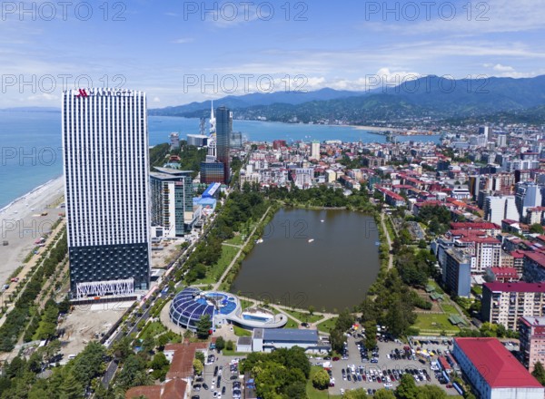 High-rise buildings on the beach with park, lake and mountains in the background, aerial view, Batumi, Black Sea, Adjara region, Adjara, autonomous republic, Georgia