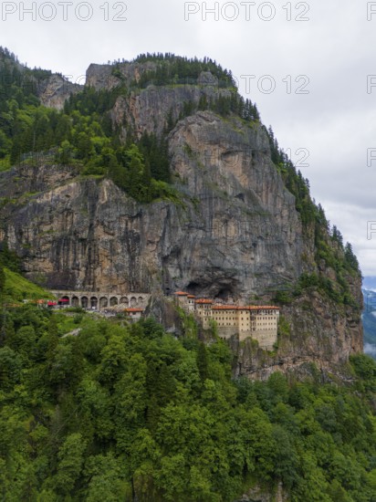A monastery perched monumentally on a steep rock face, surrounded by dense forests, aerial view, Sumela Monastery, Sümela Manastiri, Maçka, Macka, Trabzon Province, Turkey