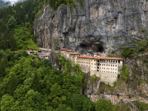 A monastery embedded in a green rocky landscape surrounded by dense forest, aerial view, Sumela Monastery, Sümela Manastiri, Maçka, Macka, Trabzon Province, Turkey