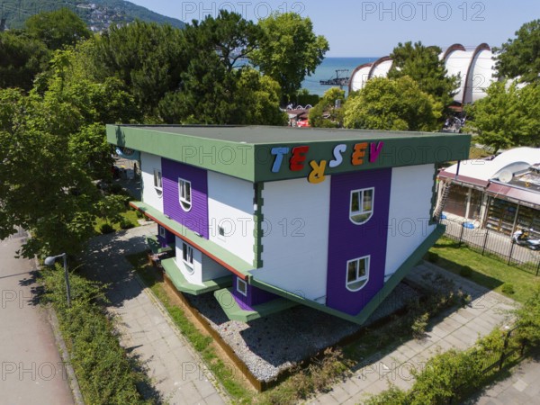 An upside down house with green and purple colours in a park surrounded by trees, aerial view, Ters Ev, upside down house, Altinordu, Altinordu, Ordu province, Turkey