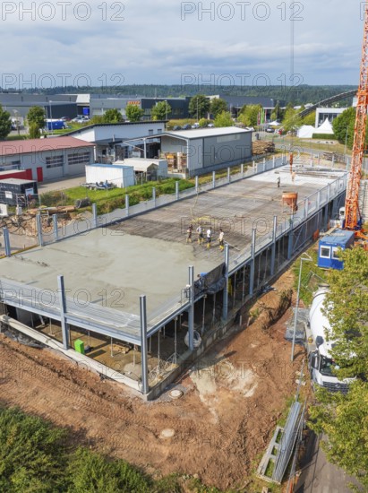 Panoramic view of a construction site with partially erected building structure and crane in the background, car park construction, Calw, Germany