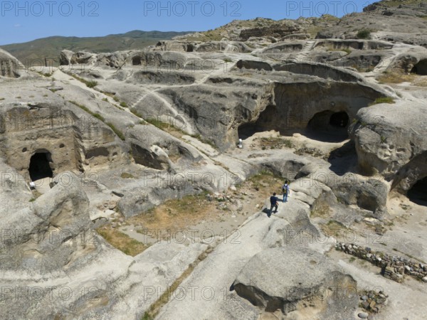 Archaeological site with sandstone cave structures under a clear sky, aerial view, Uplistsikhe cave town, Uplistsikhe, Inner Kartli region, Shida Kartli, Georgia