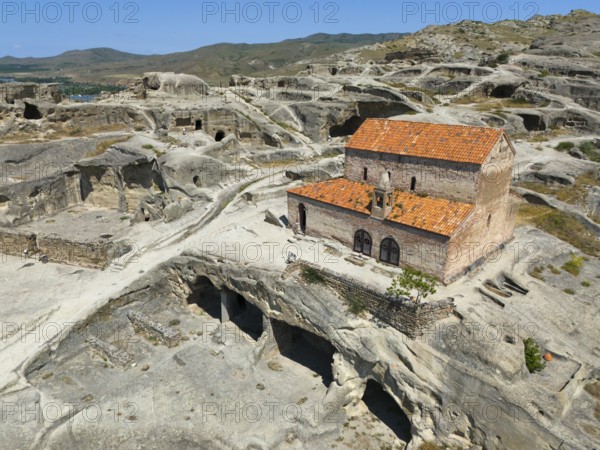 Fascinating ruins of Uplistsikhe with orange tiled roofs in the middle of a rocky landscape, aerial view, Princes' Church, Uplistsikhe cave town, Uplistsikhe, Inner Kartlia region, Shida Kartli, Georgia