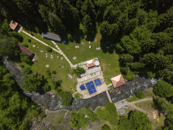 Aerial view of a forest area with swimming pool, river and surrounding buildings, surrounded by dense nature, aerial view, outdoor swimming pool, sulphur springs of Borjomi, Borjomi, Samtskhe-Javakheti region, Kura river, Lesser Caucasus, Georgia