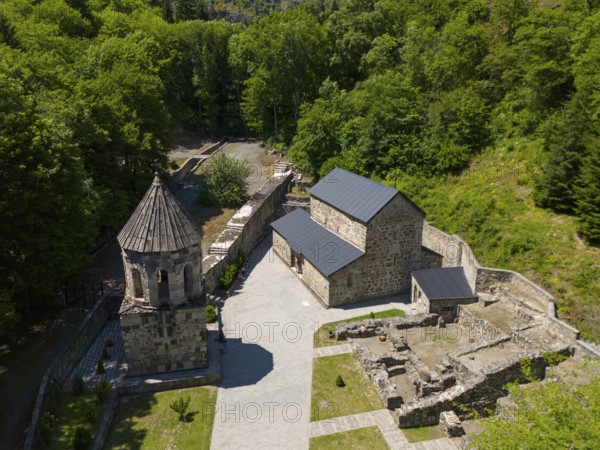 Historic monastery complex embedded in a forest, with ruins and stone structures, aerial view, Chitakhevi Church of St George, The Green Monastery, Mtsvane Monastery, Samtskhe-Javakheti region, Georgia