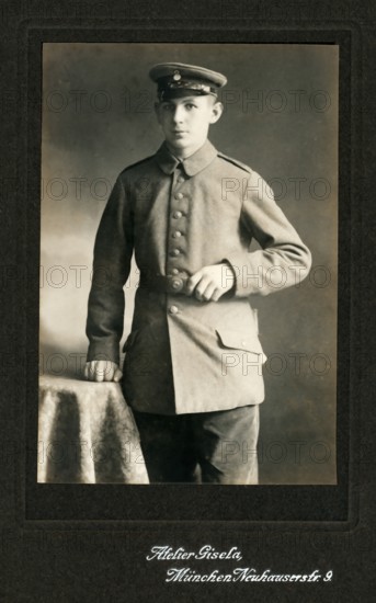 Young man with simple uniform, studio photograph, around 1910