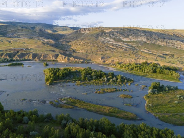 A picturesque river landscape with green islands and surrounding hills under a blue sky, aerial view, River Kura or Mtkvari, near Uplistsikhe, Uplistsikhe, Inner Kartlia region, Shida Kartli, Georgia