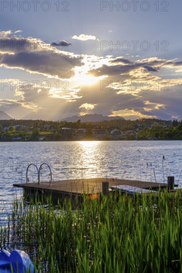 Bathing jetty at sunset on the lake near Neuegg am Faaker See, Carinthia, Austria