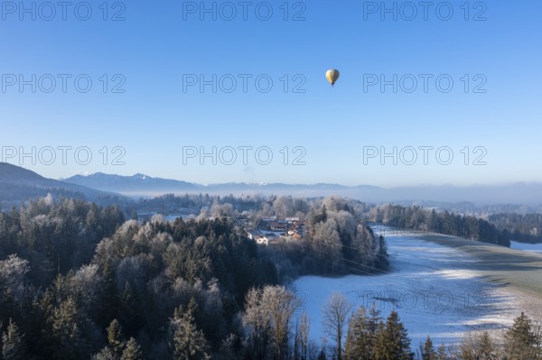 Hot air balloon in winter over Bad Heilbrunn, Upper Bavaria, Bavaria, Germany