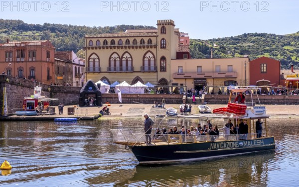 Sardinia, boats in the river Temo and houses on the promenade, guests at the restaurants with outdoor catering, Bosa, Europe, Province of Oristano, Italy, old town, architecture, view, outdoor catering, boats, bridge, facade, river Temo, leisure, gastronomy, guests, landscape, afternoon, recreation, outdoor, promenade, travel, restaurants, boat, sightseeing, dining, late summer, town, scenery, tourism, shore, water, residential buildings, relaxed, historical, Italian, cultural, local, picturesque, Mediterranean, Mediterranean climate