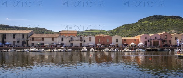 Sardinia, boats in the river Temo and houses on the promenade, guests at the restaurants with outdoor catering, Bosa, Europe, Province of Oristano, Italy, activity, everyday life, architecture, outdoor catering, boats, dolce vita, relaxation, fishing, river, leisure, building, guests, sky, culture, landscape, people, promenade, restaurants, sightseeing, summer, dining, town, chairs, scenic, daylight, temo, table, tourism, drinking, shore, surroundings, holiday, resort, water, residences, charming, historical, Mediterranean