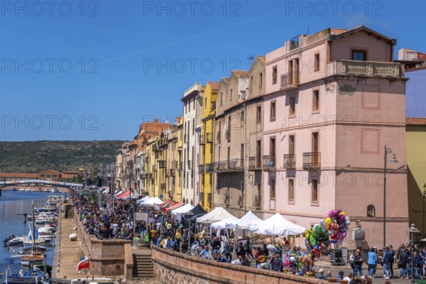 Sardinia, boats in the river Temo and houses on the promenade, guests at the restaurants with outdoor catering, Bosa, Europe, Province of Oristano, Italy, architecture, atmosphere, view, outdoor catering, visitor infrastructure, boats, relaxation, food, river Temo, riverbank, leisure, spring, buildings, guests, facades, culture, noon, seagulls, promenade, travel, restaurants, restaurant terraces, sightseeing, summer, sun, cityscape, tourism, tourists, waterfront, holiday, means of transport, water, residential buildings, European city, Italian, local, picturesque, Mediterranean