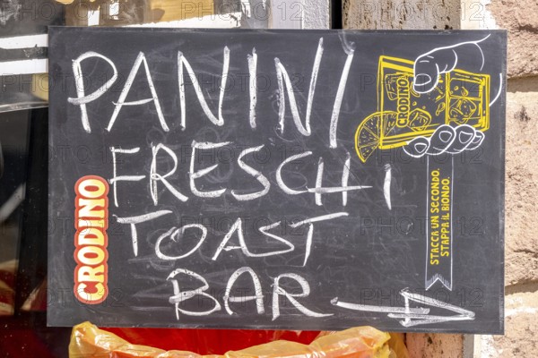Sardinia, sign with Panini Freschi Toast Bar, Bosa, Europe, Province of Oristano, Italy, outdoor, cafe, food, fresh, gastronomy, sign, shop, orientation, Panini Freschi, destination, restaurant, direction, font, lettering, sightseeing, snack, city, daylight, toast bar, tourism, environment, urban, landmark, advertising, decoration, colourful, Italian, local cuisine, Mediterranean, stylish, touristy
