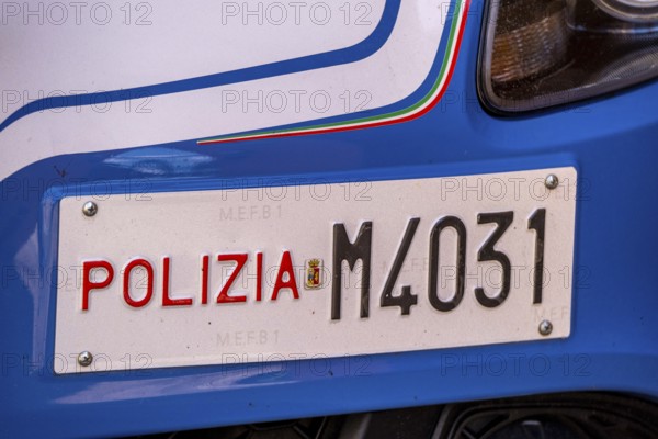 Sardinia, Alfa Romeo police car and police sign Polizia M4031, Bosa, Europe, Province of Oristano, Italy, Alfa Romeo, police car, police sign, Polizia, vehicle, car, police, security forces, traffic, roads, urban, service vehicle, number plate, transport, European, Italian, public service, order, protection, blue, white, city, architecture, infrastructure, protection services, motorised, emergency vehicle, Mediterranean, summer, technology, design