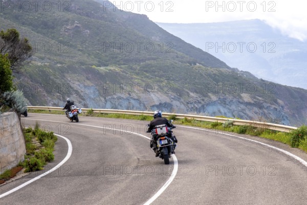 Sardinia, biker motorcyclist on the mountainous coastal road, Villanova Monteleone, Europe, Province of Sassari, Italy, adventure, asphalt, view, mountainous, movement, biker, discovery, exploration, experience, ride, airstream, vehicle, freedom, leisure, freshness, speed, helmet, sky, hills, curves, coastal road, landscape, sea view, motorcyclist, nature, outdoor, panorama, journey, traveller, protective clothing, sightseeing, summer feeling, road, day, touring, tourism, transport, holidaymaker, Italian, picturesque, vegetation