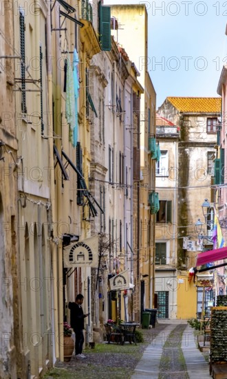 Sardinia, alley in the old town, fabric panels on the balconies and lamps, Alghero, Europe, province of Sassari, Italy, old town, architecture, atmosphere, exterior, balconies, lighting, shutters, photography, alley, building, lamps, cobblestones, travel, shadow, sight, sightseeing, summer, city view, fabric panels, alleyway, textiles, tourism, decorative, narrow, historical, Italian, cultural, picturesque, Mediterranean, quiet, traditional, urban landscape