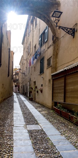 Sardinia, Narrow cobblestone alley and houses in the old town, Laundry by the window, Alghero, Europe, Province of Sassari, Italy, old building, old town, architecture, atmosphere, balconies, narrow alley, exploration, window, shutters, alley, building, houses, Idyllic, cobblestone, culture, travel, destination, sight, sightseeing, city, city life, alleyway, tourism, urban, neighbourhood, laundry, foreign, authentic, charming, narrow, historic, picturesque, Mediterranean, square, traditional