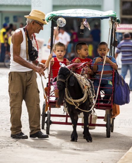 &lt, children's amusement, children's carriage pulled by a goat, streetlife in the city centre of Santa Clara at the Parque de Santa Clara, Santa Clara, Cuba, Villa Clara