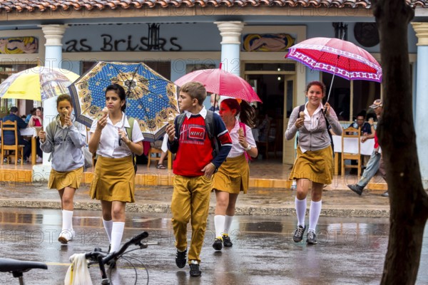 School children, pupils crossing a street in Vinales, Viñales, Cuba, Pinar del Río, Viñales, Pinar del Río