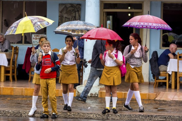 School children, pupils crossing a street in Vinales, Viñales, Cuba, Pinar del Río, Viñales, Pinar del Río