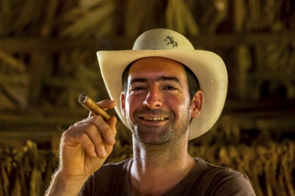 Tobacco farmer, tobacco farmer Luis Manne Alvares Rodrigues smokes a Havana cigar, tobacco farm in the Vinales Valley, Viñales, Cuba, Pinar del Río, Viñales, Pinar del Río