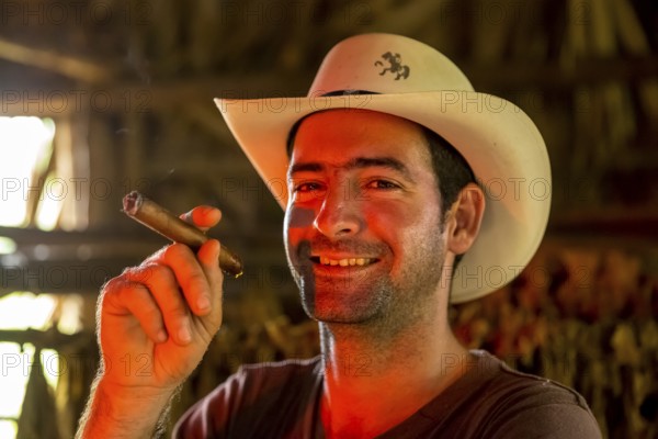 Tobacco farmer, tobacco farmer Luis Manne Alvares Rodrigues smokes a Havana cigar, tobacco farm in the Vinales Valley, Viñales, Cuba, Pinar del Río, Viñales, Pinar del Río